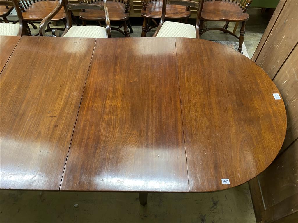 A George III mahogany D end dining table, on square tapered legs, with three spare leaves, 274cm extended, one spare leaf, width 107c